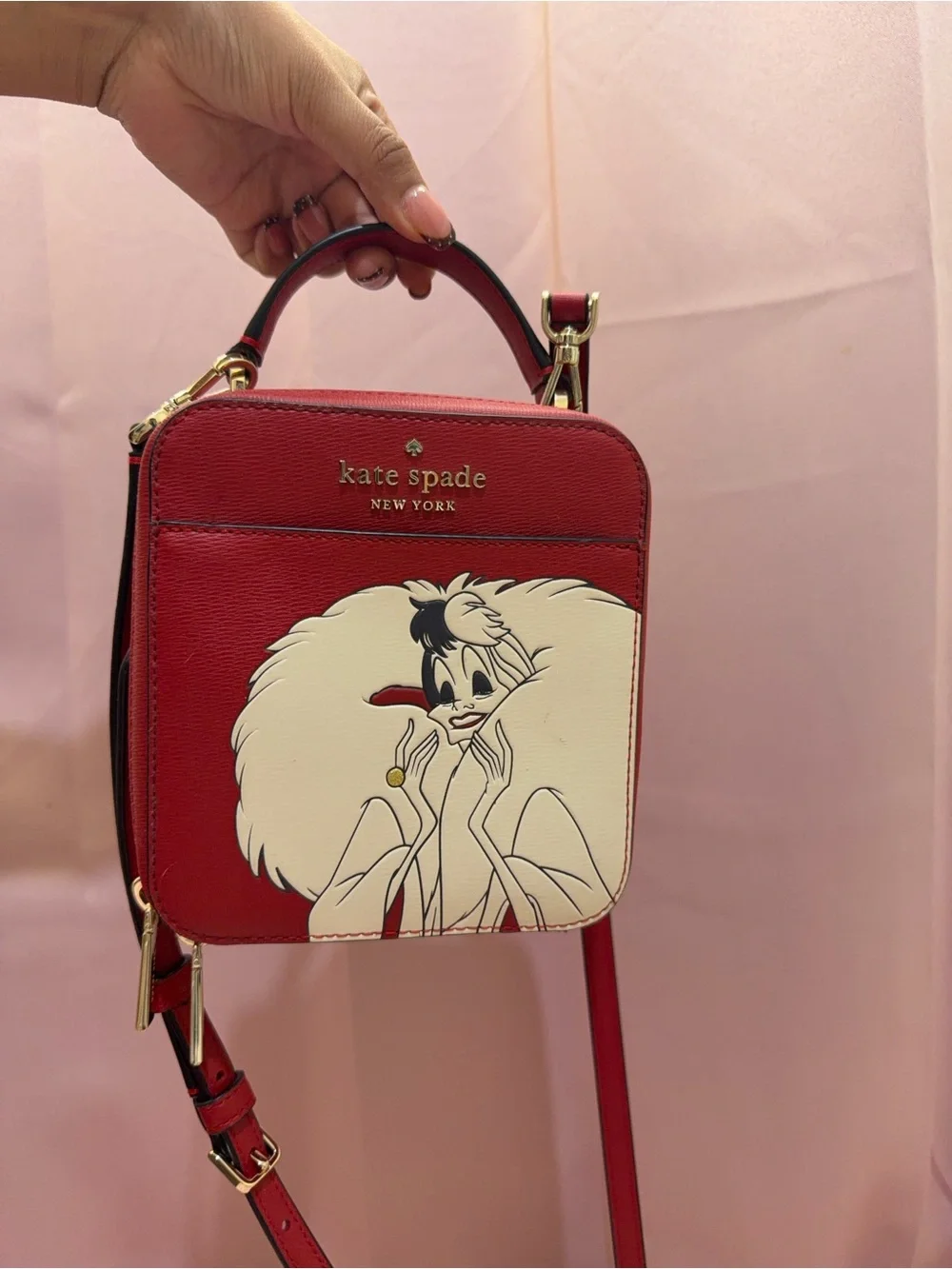 kate spade red and cream Cruella-themed crossbody bag